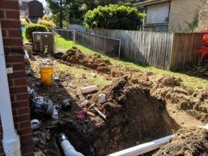 The side yard all dug up and new pipes being installed.