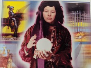 Amanda's face superimposed on a dark-haired person holding a crystal ball.