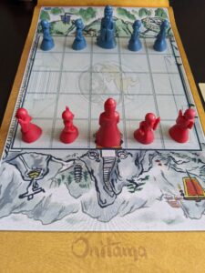 A game setup similar to chess with little dudes facing off from each other.