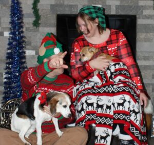 Christmas photo. Gabe is pointing and you can't see his face, Edie looks sad. Arthur looks like he'd rather be somewhere else and I'm laughing at Gabe pointing.