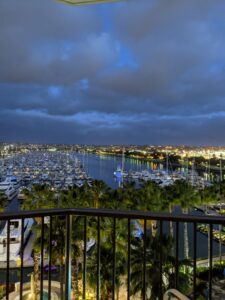 Looking off of my hotel balcony in the earlyl morning over the marina. Lots of boats, the sky is cloudy and just starting to show light.