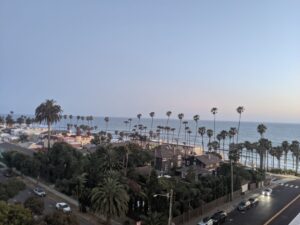 Looking out from the top of the last hotel. Overlooks the Pacific Ocean, about a block away, and there are palm trees and blue sky, some building, but just pretty.