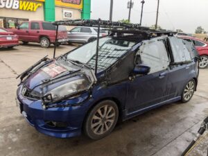 A blue Honda Fit in Texas kitted out as a storm chaser vehicle.