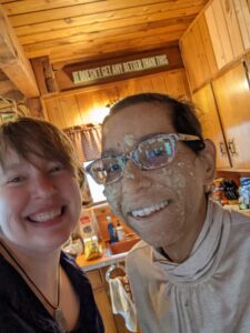 Lucy and I, selfie. I am smiling and she is too, but she's also covered in mud from the ATV ride they took.